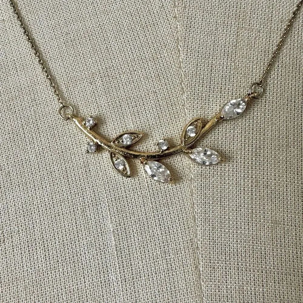 Gold tone rhinestone leaf pendant necklace